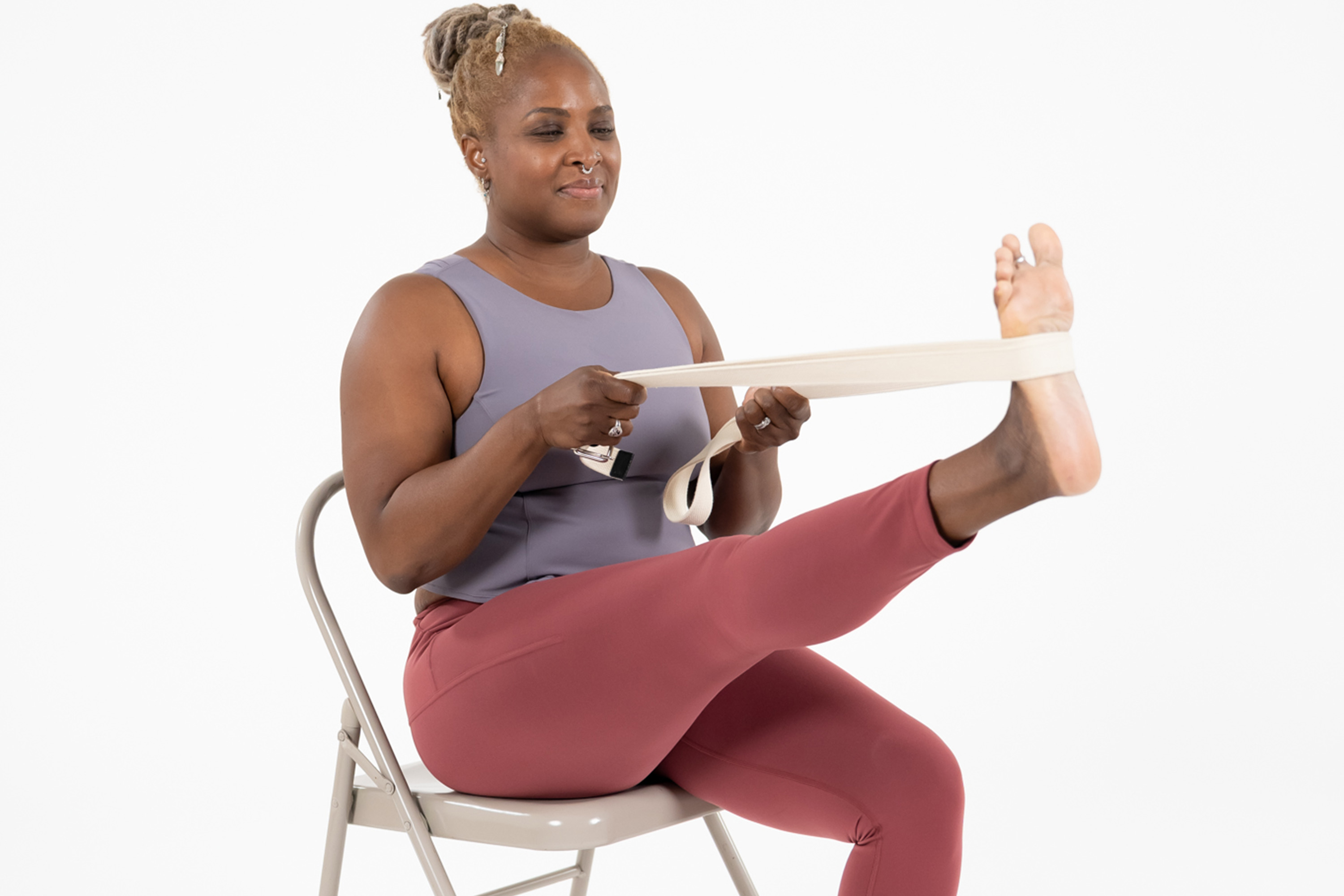 Woman in a modified yoga pose while sitting in a chair